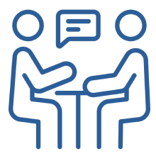 Two people sitting at a table having a conversation.