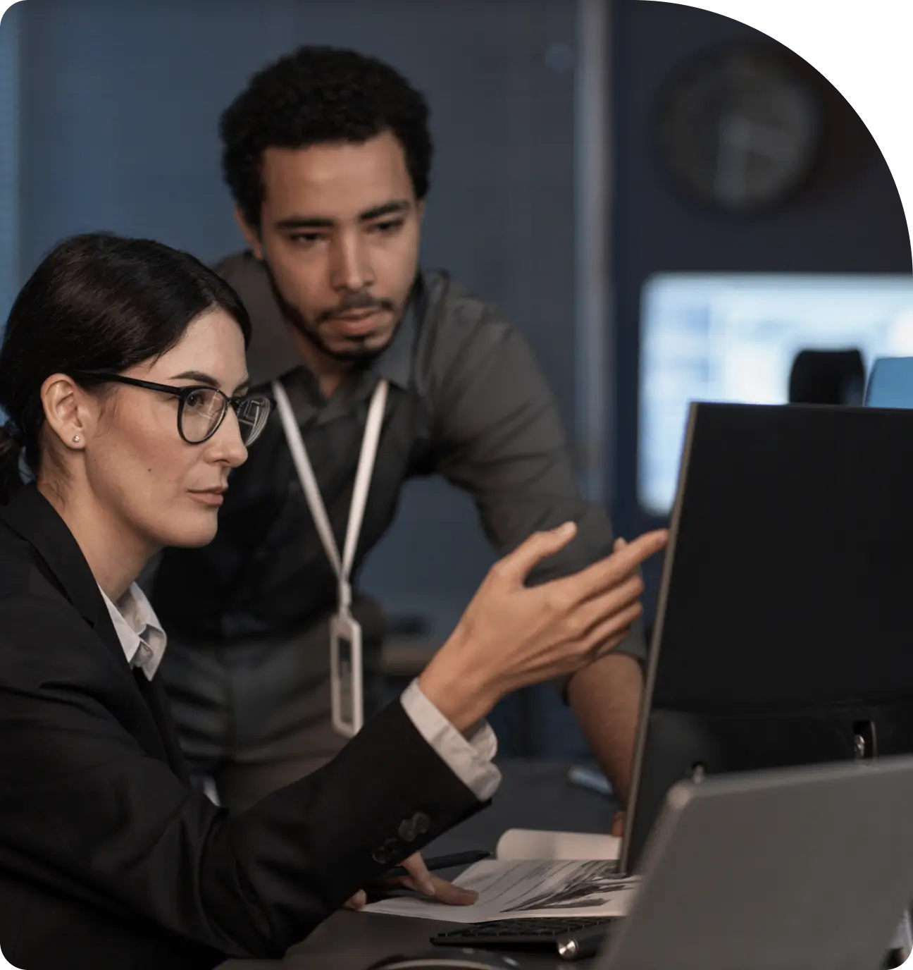 Colleagues discussing work in front of computer.
